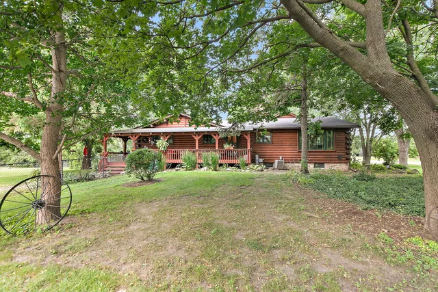 a view of a patio with lawn chairs floor to ceiling window with wooden floor