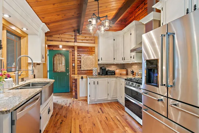 a kitchen with stainless steel appliances a sink stove and cabinets