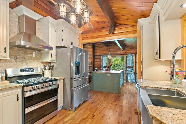 a room with granite countertop a couch and wooden floor