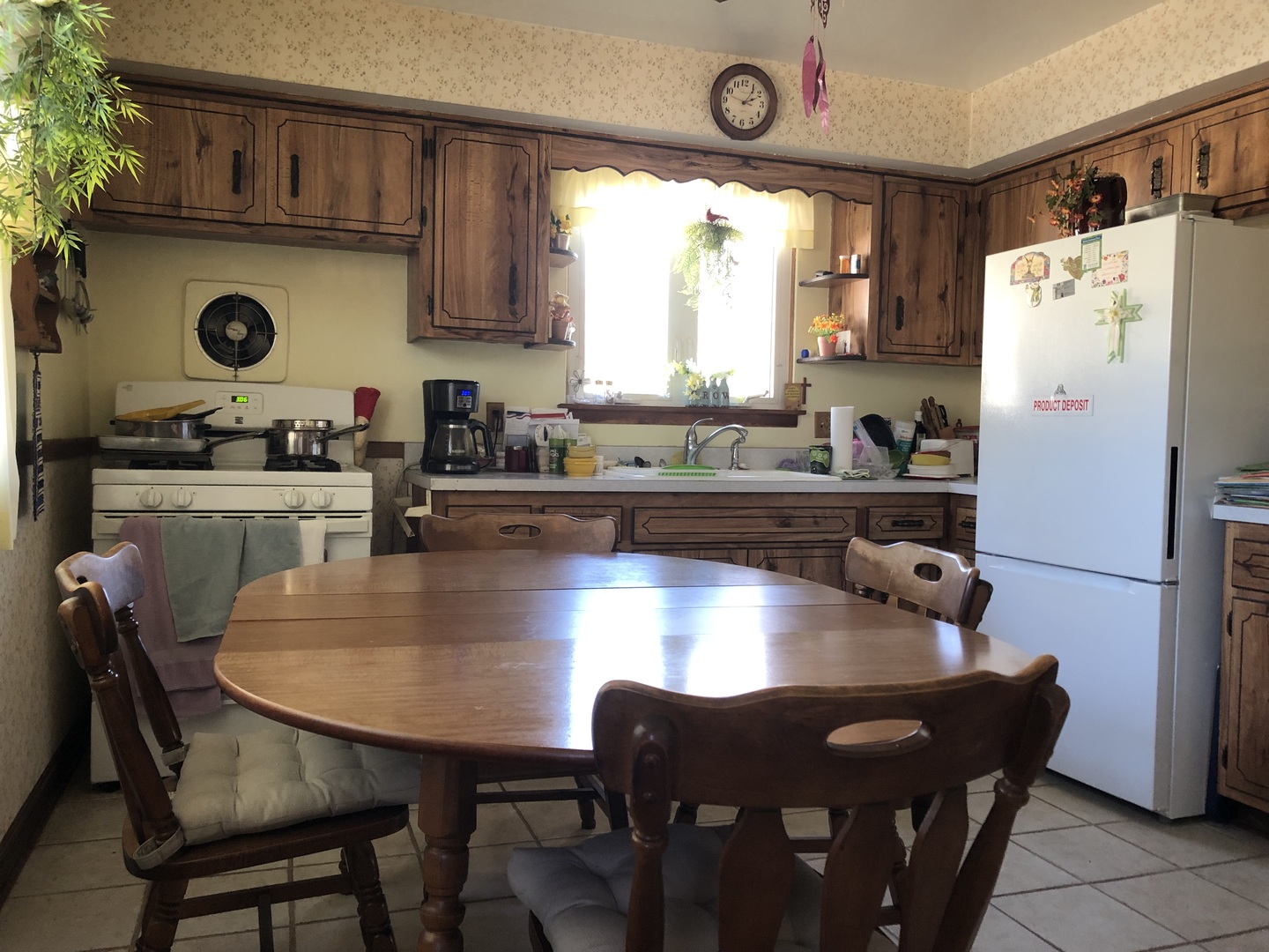 1208 Waverly Place Joliet, IL 60435 - Photo 3 of 18 a kitchen with a table chairs and a refrigerator