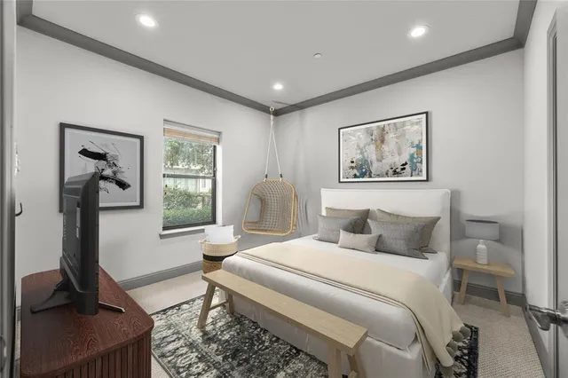 a bedroom with a bed a couch and a window