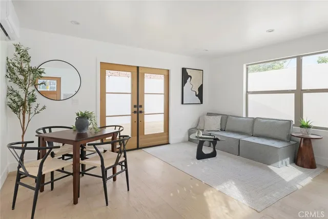 a living room with furniture a table and white walls