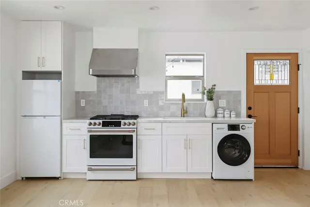 a living room with furniture a flat screen tv and a window