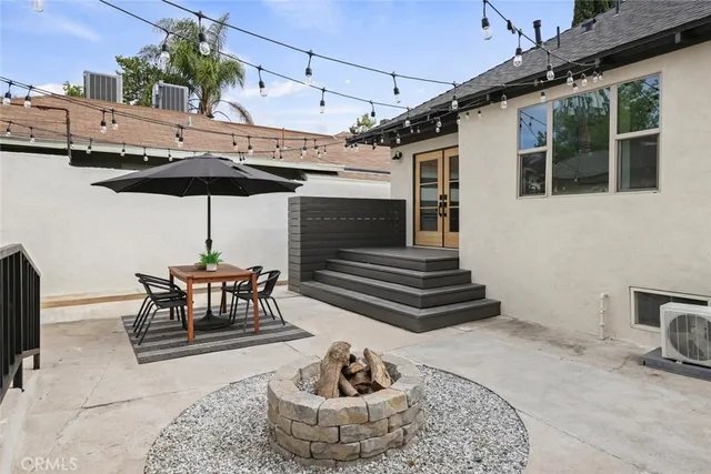 a bedroom with a bed and a potted plant on the dresser