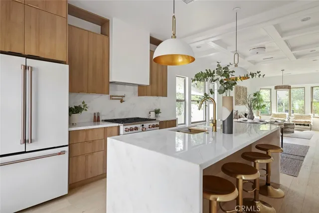 a kitchen with stainless steel appliances granite countertop a sink a stove and a refrigerator