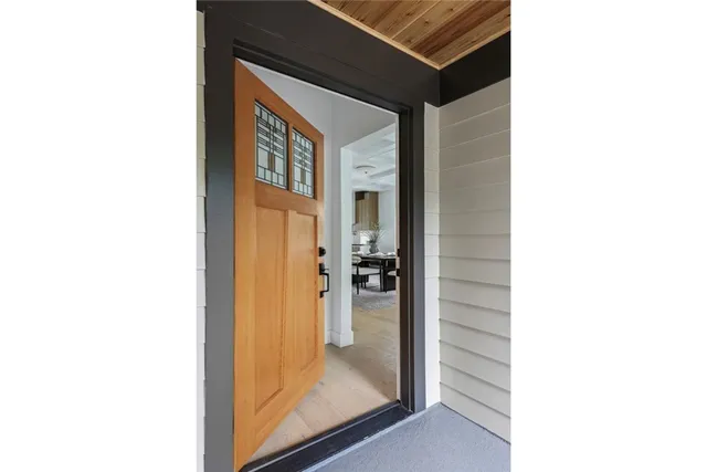 a view of a white house with large tree