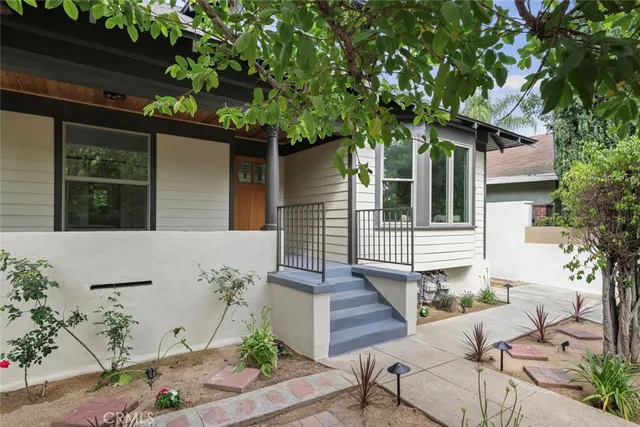 a view of a house with a tree