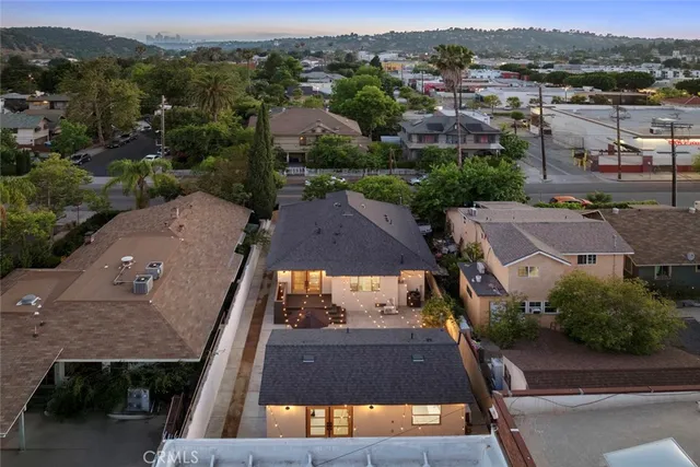 an aerial view of a house with a yard
