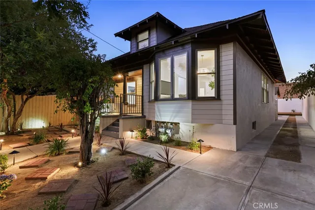 a front view of a house with tree