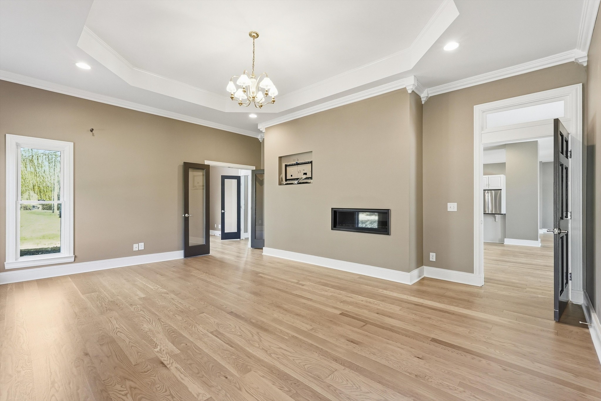 2005 Alan John Way Lebanon, TN 37087 - Photo 13 of 71 a view of an empty room with wooden floor and a kitchen