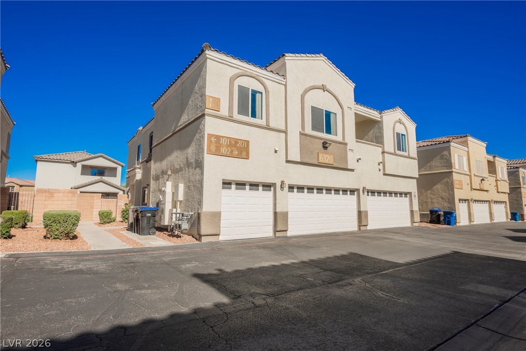 6320 Snap Ridge Street, Unit 201 North Las Vegas, NV 89081 - Photo 47 of 56 Attached garages provide convenience for these stucco-finished multi-family residences.