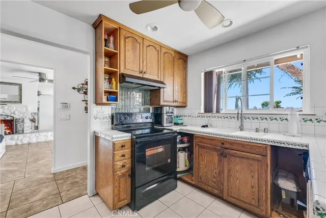 a kitchen with a sink stove and cabinets
