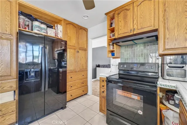 a kitchen with stainless steel appliances granite countertop a stove and a refrigerator