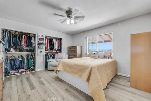 a bedroom with bed and a chandelier