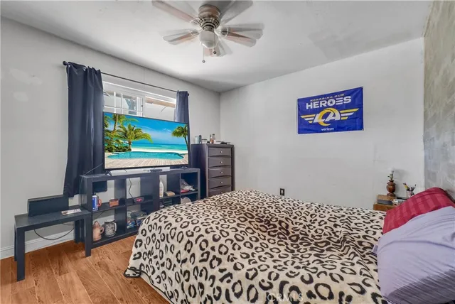 a bedroom with a bed and a flat screen tv