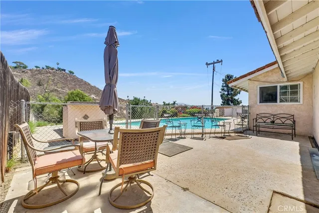 a patio with a table and chairs