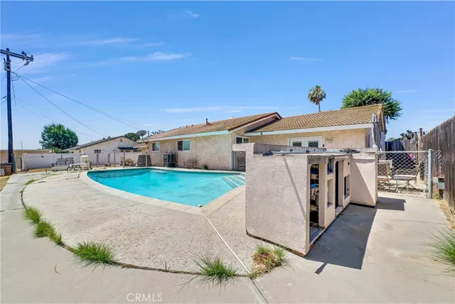 a view of a white house with a big yard and large trees
