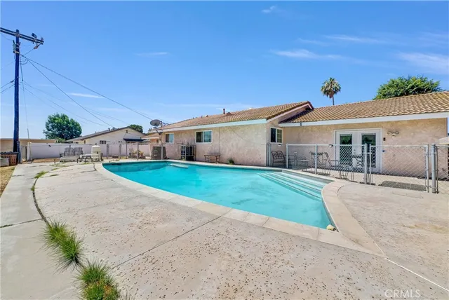 a front view of house with a yard and potted plants