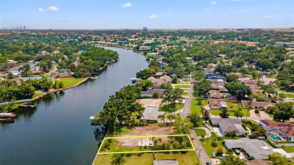 an aerial view of residential houses with outdoor space and river