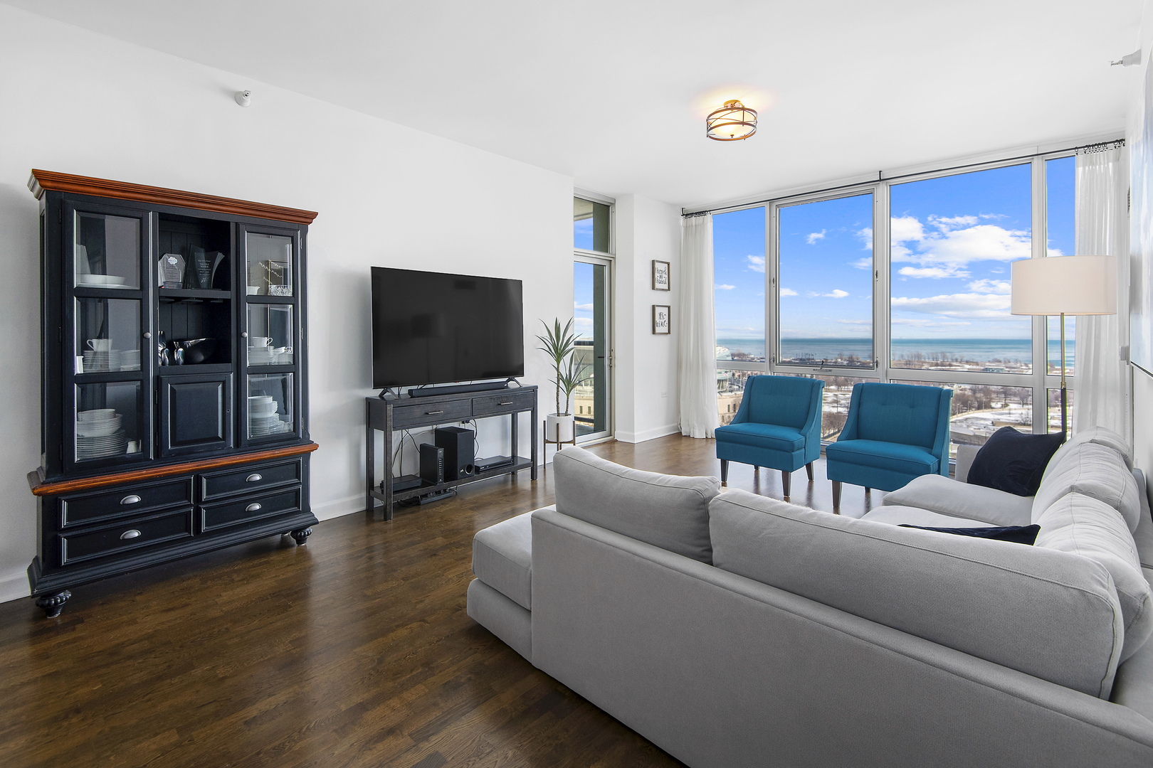 1629 South Prairie Avenue, Unit 1602 Chicago, IL 60616 - Photo 3 of 23 a living room with furniture and a flat screen tv