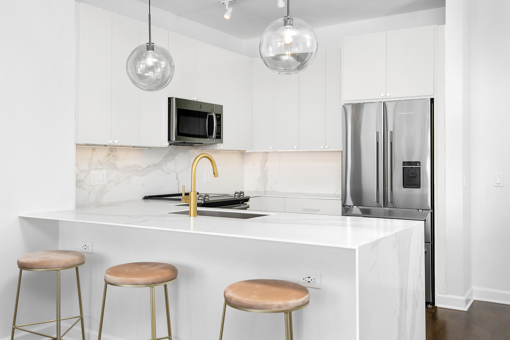 1629 South Prairie Avenue, Unit 1602 Chicago, IL 60616 - Photo 7 of 23 a kitchen with stainless steel appliances granite countertop a sink a stove refrigerator and microwave