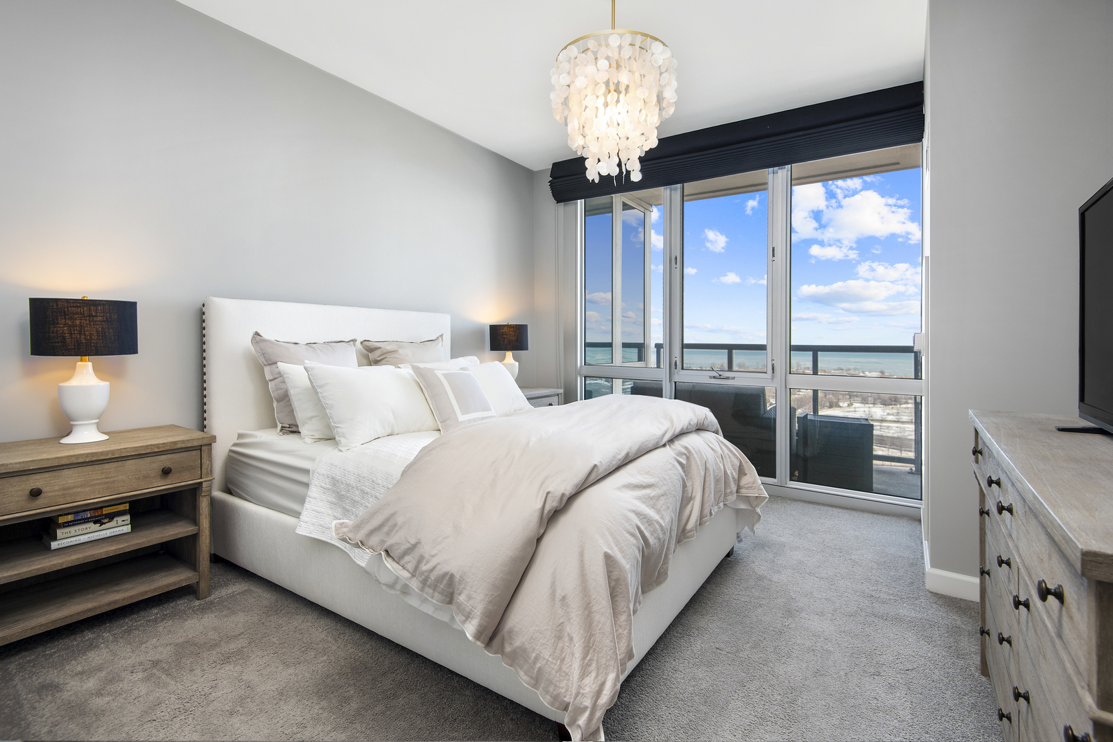 1629 South Prairie Avenue, Unit 1602 Chicago, IL 60616 - Photo 10 of 23 a bedroom with a large bed and a flat tv screen on dresser