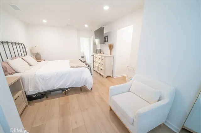 a bedroom with a bed and a couch