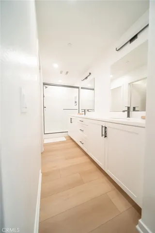 a view of a kitchen with white cabinets