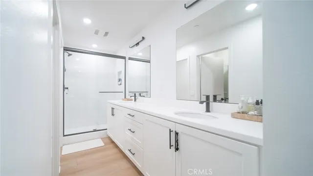 a bathroom with a double vanity sink mirror and double