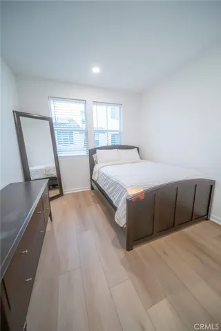 a bedroom with a bed a table and window