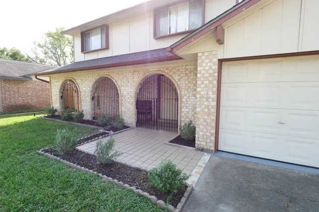 a front view of a house with garden