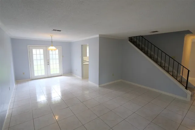 a view of an empty room with glass door
