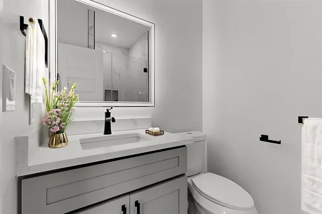 a bedroom with a bed and a potted plant