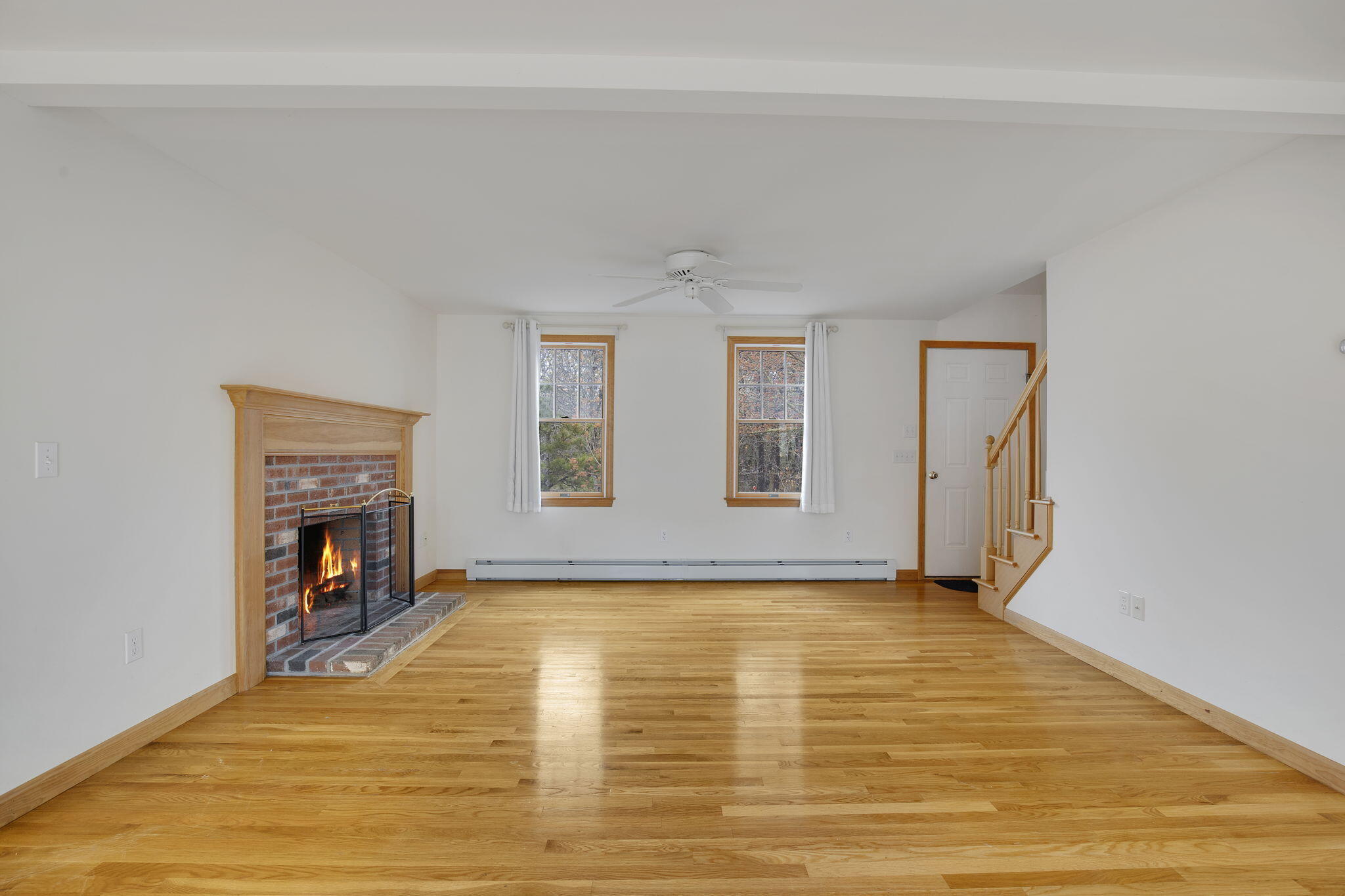 65 Whitney Road Eastham, MA 02642 - Photo 16 of 41 a view of an empty room with a fireplace and a window