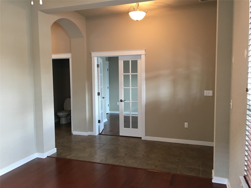 1924 Littlefield Street Austin, TX 78723 - Photo 2 of 19 an empty room with wooden floor and windows