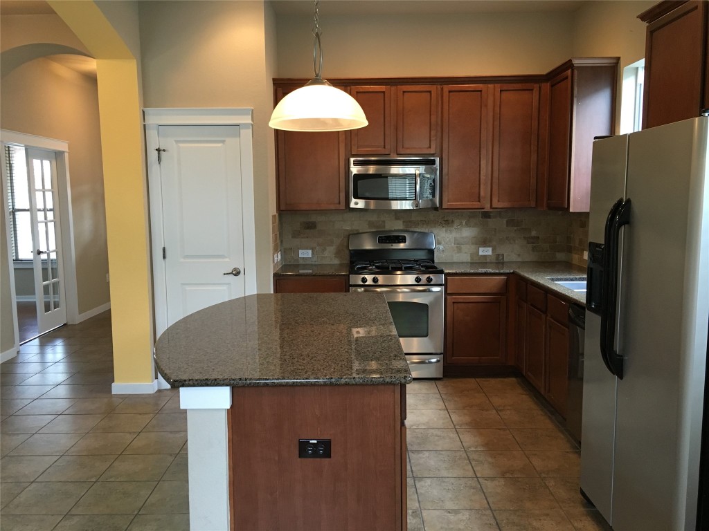 1924 Littlefield Street Austin, TX 78723 - Photo 5 of 19 a kitchen with stainless steel appliances granite countertop a sink stove and refrigerator