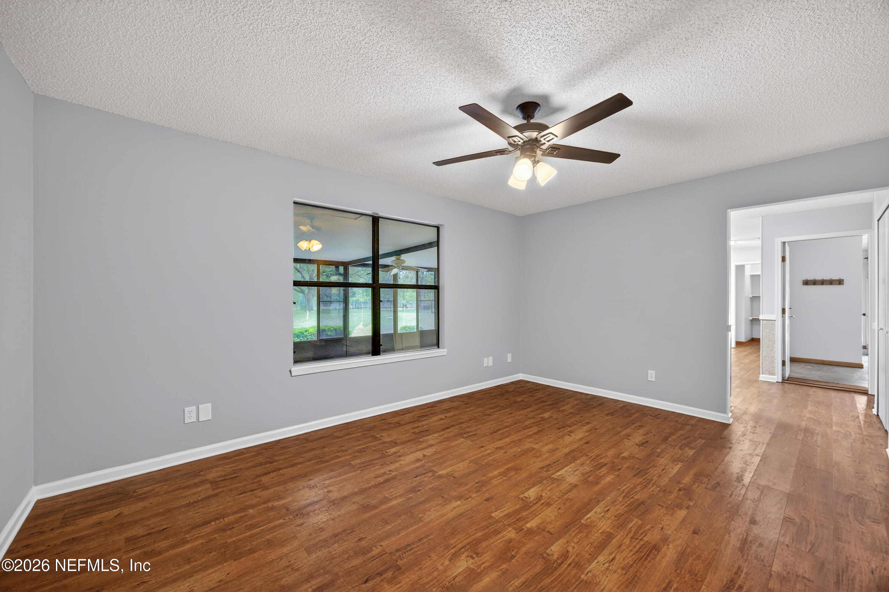 4537 Junction Drive Middleburg, FL 32068 - Photo 11 of 62 a view of an empty room with window and wooden floor