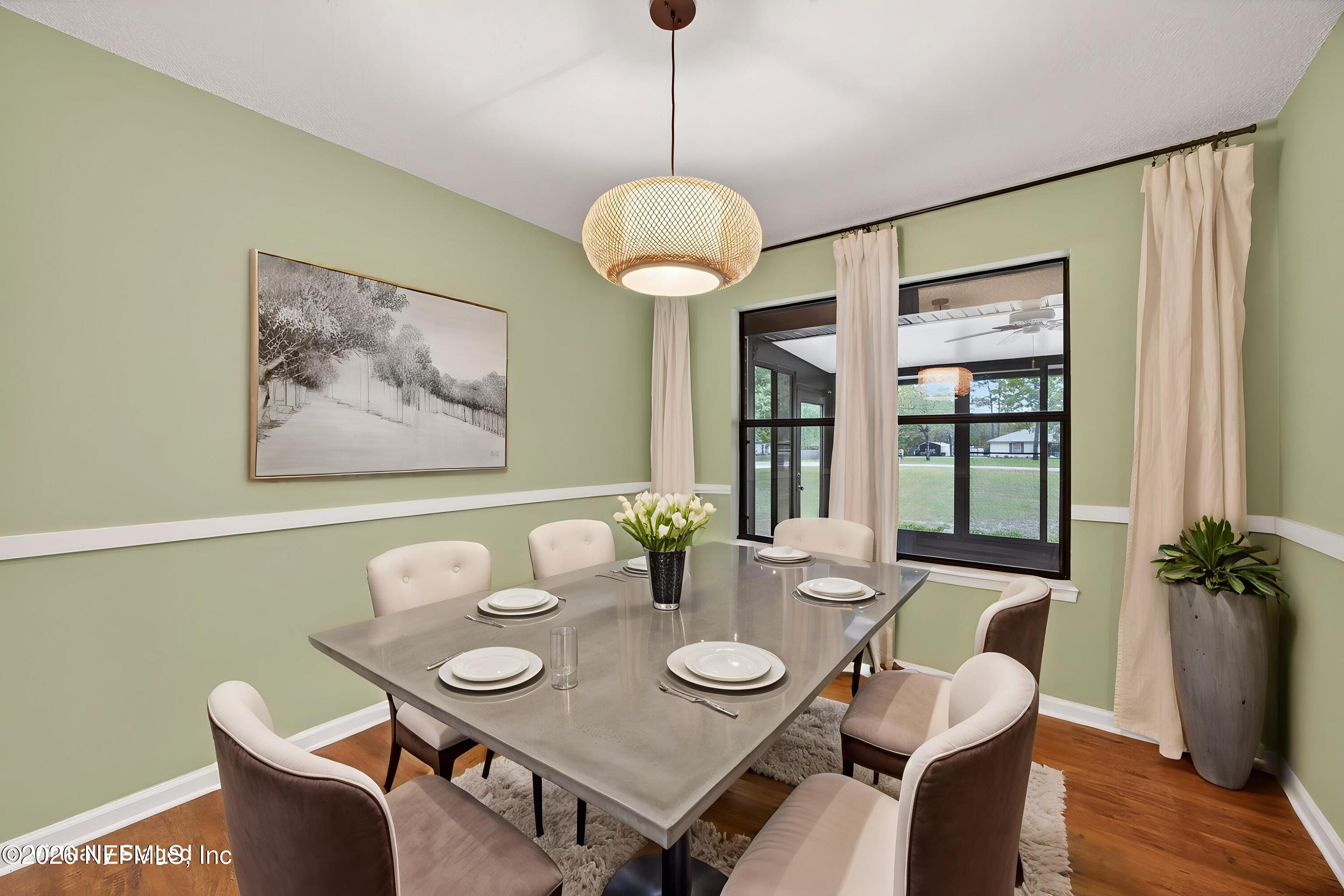 4537 Junction Drive Middleburg, FL 32068 - Photo 14 of 62 a view of a dining room with furniture window and wooden floor