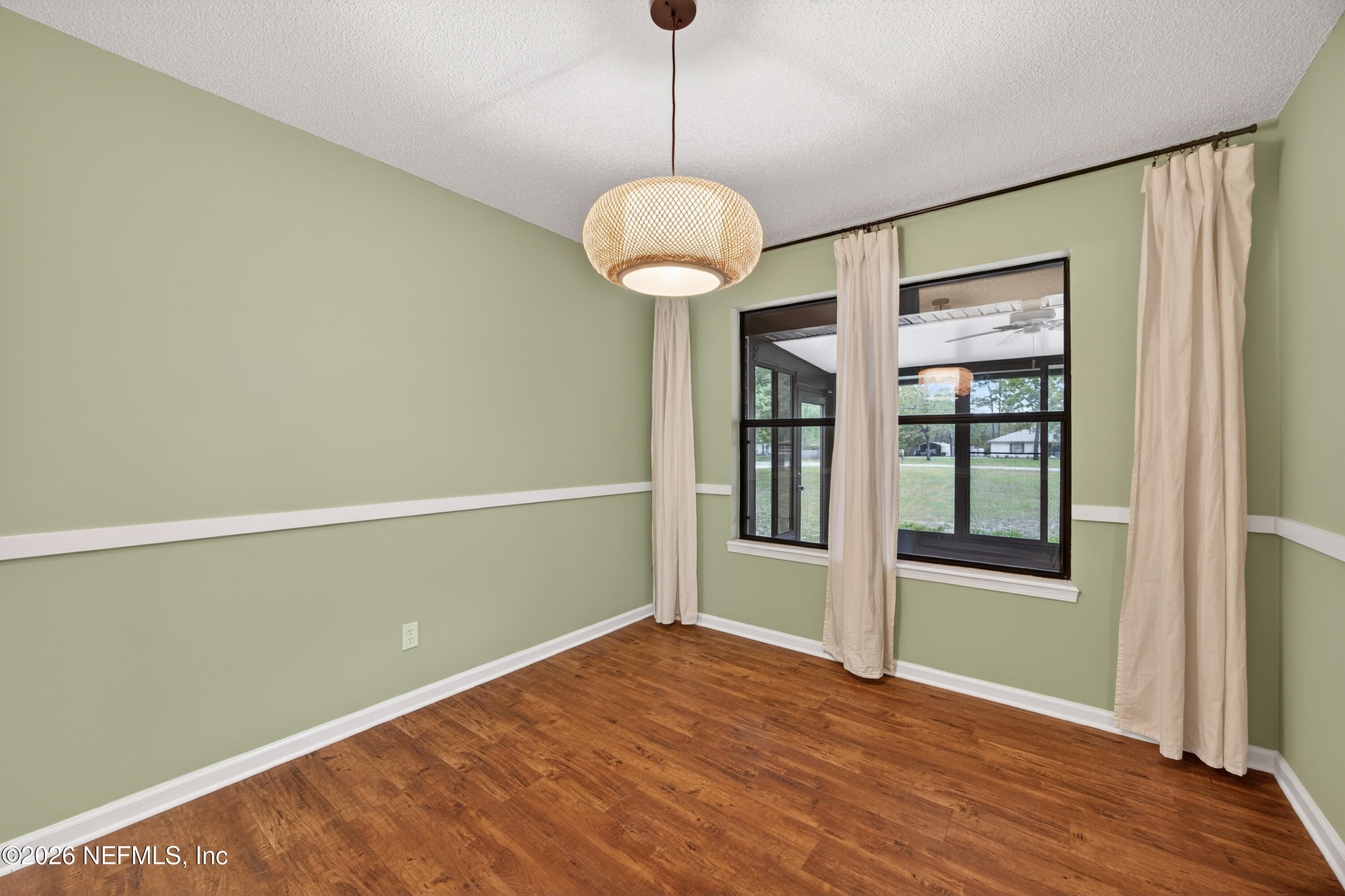 4537 Junction Drive Middleburg, FL 32068 - Photo 15 of 62 a view of an empty room with a window and wooden floor