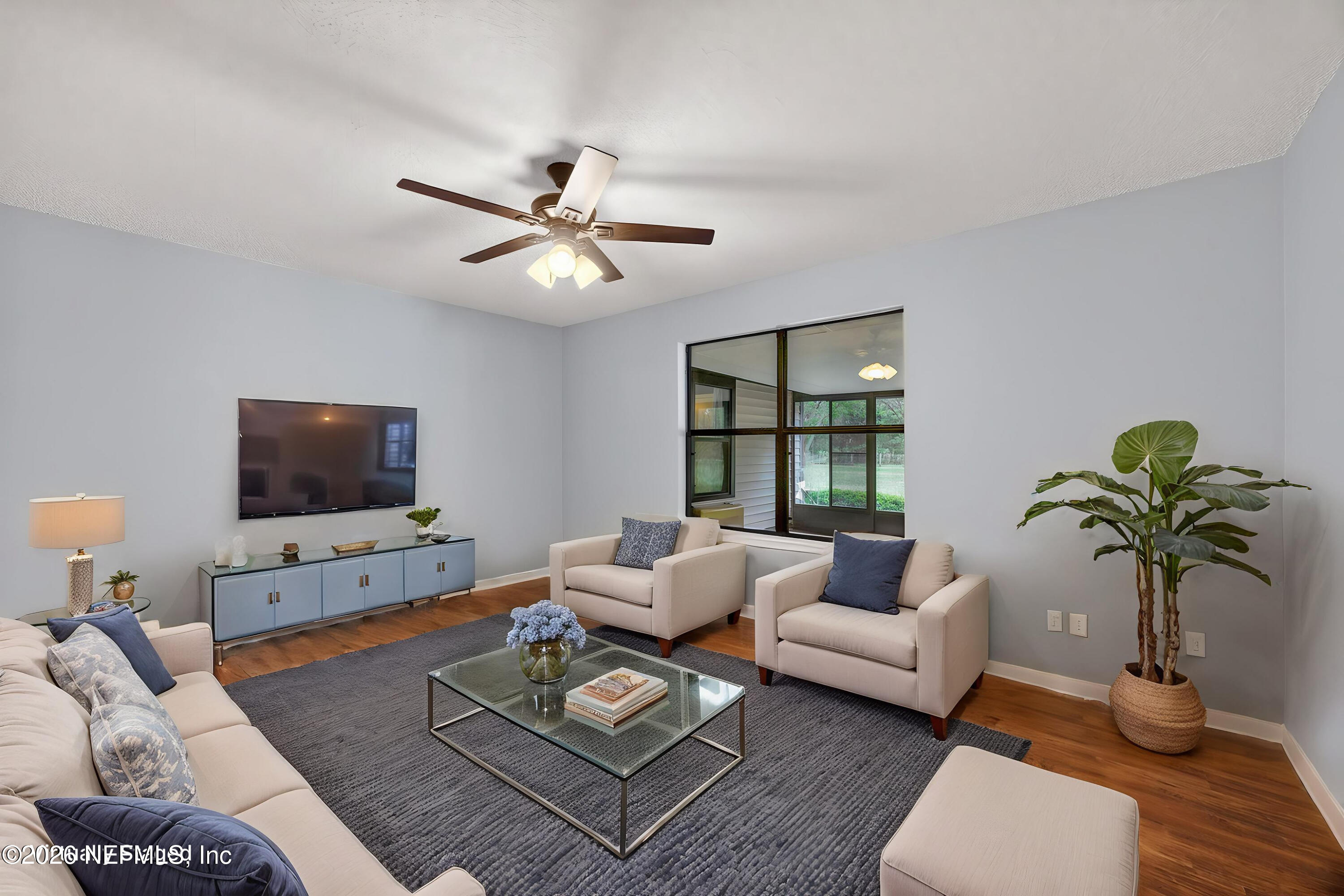 4537 Junction Drive Middleburg, FL 32068 - Photo 17 of 62 a living room with furniture a flat screen tv and a potted plant