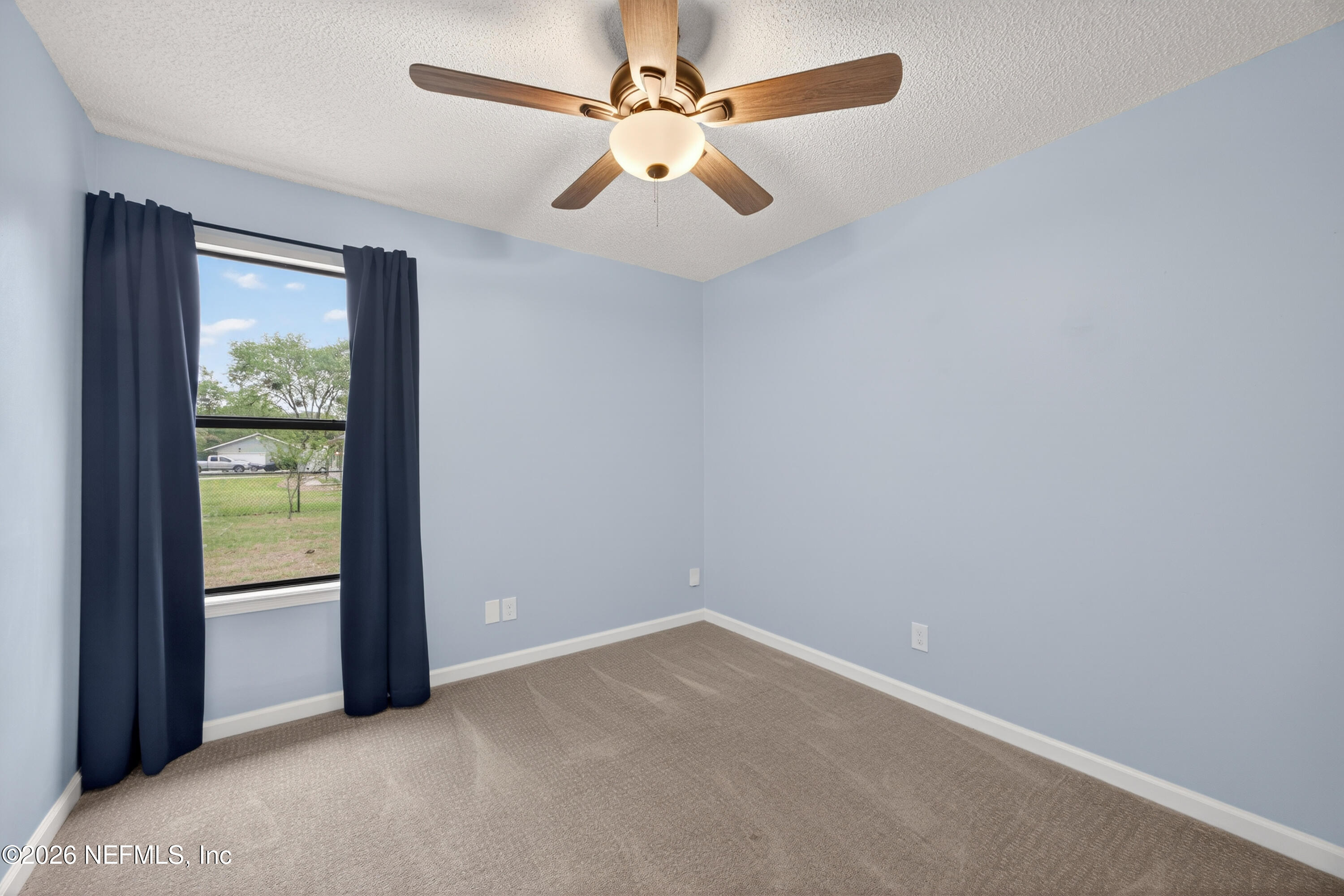 4537 Junction Drive Middleburg, FL 32068 - Photo 30 of 62 an empty room with a window and a fan
