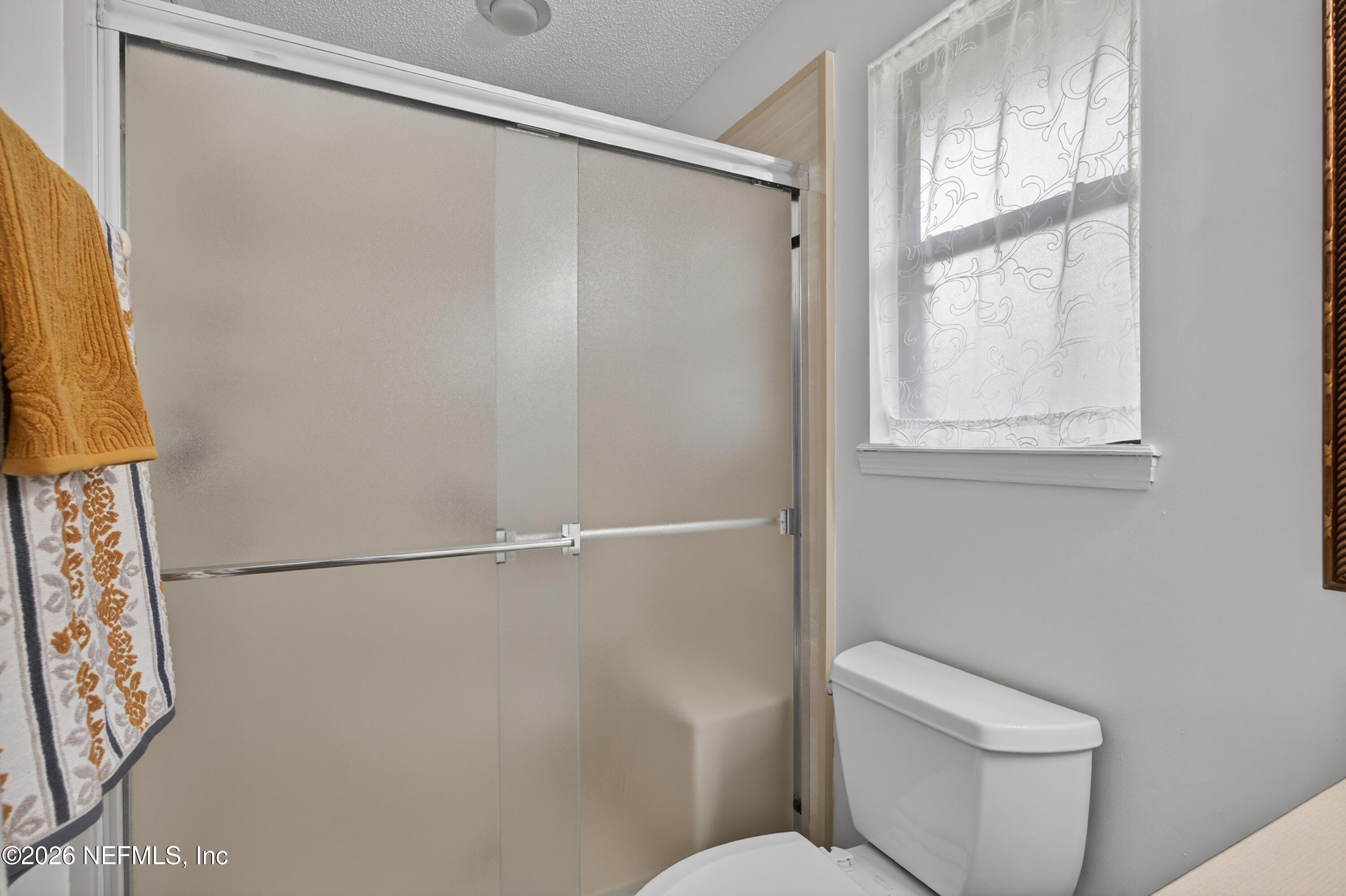 4537 Junction Drive Middleburg, FL 32068 - Photo 35 of 62 a white toilet sitting next to a window in a bathroom