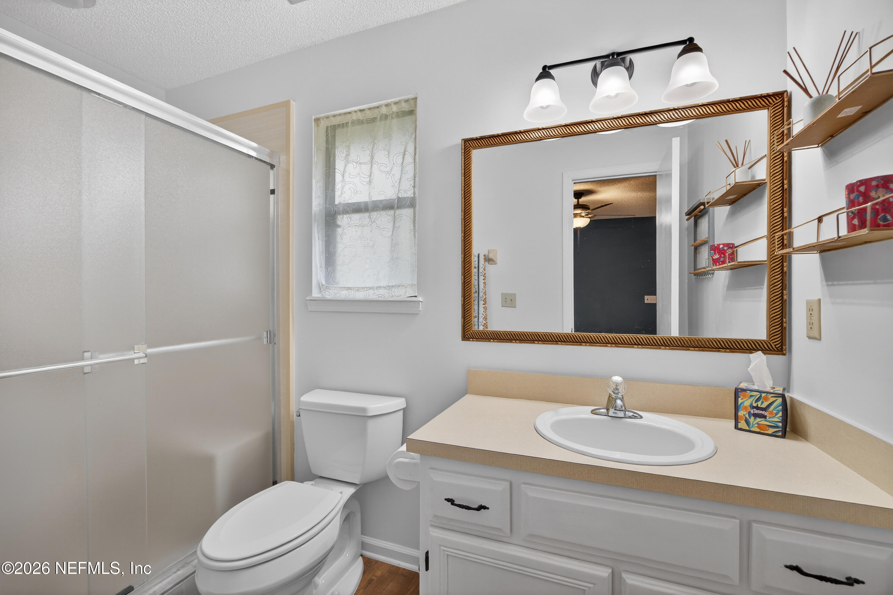 4537 Junction Drive Middleburg, FL 32068 - Photo 36 of 62 a bathroom with a sink toilet vanity and shower