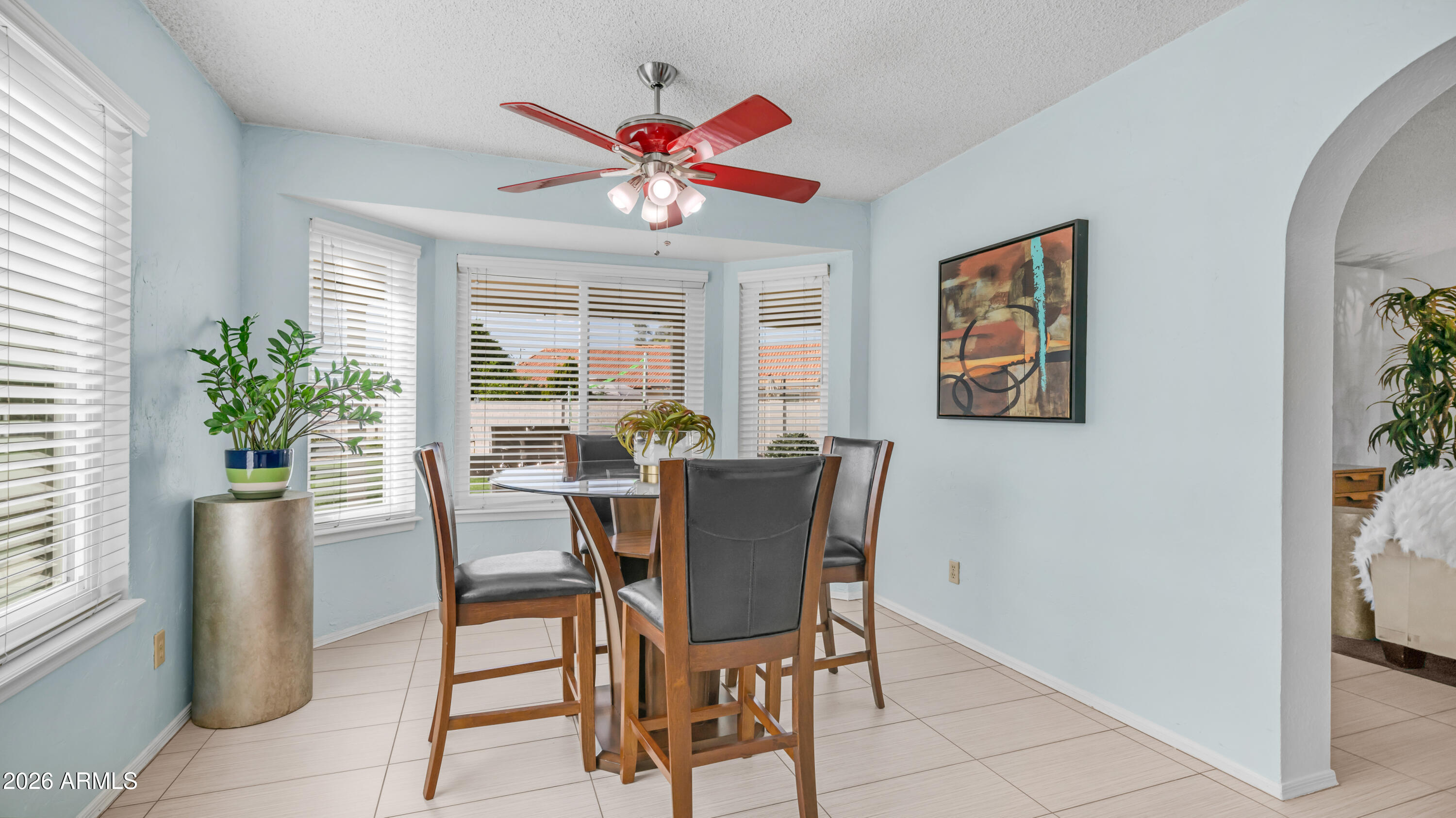 408 East Meadows Lane Gilbert, AZ 85234 - Photo 13 of 42 a view of a dining room with furniture and a potted plant