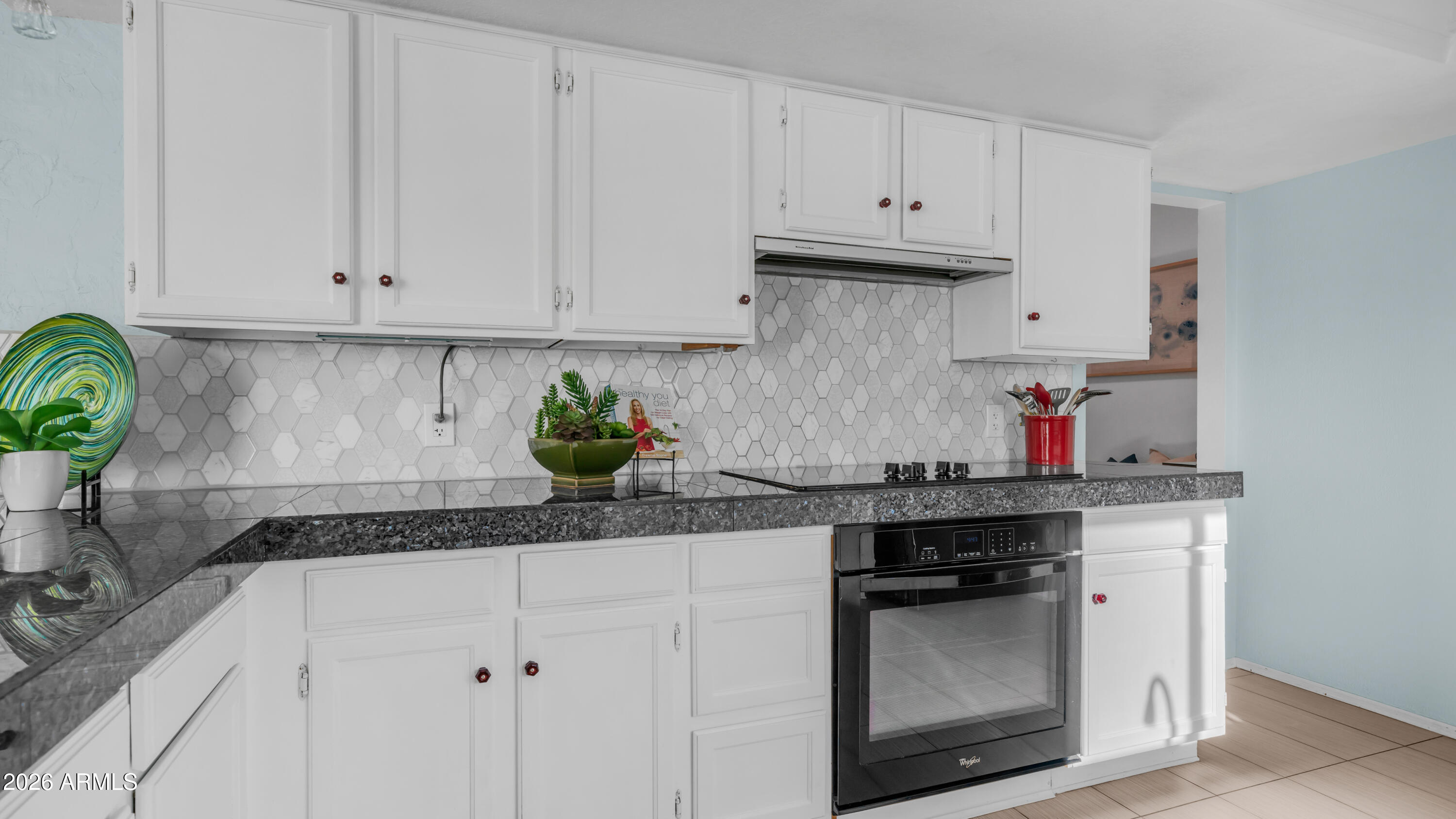 408 East Meadows Lane Gilbert, AZ 85234 - Photo 14 of 42 a kitchen with granite countertop white cabinets and a stove