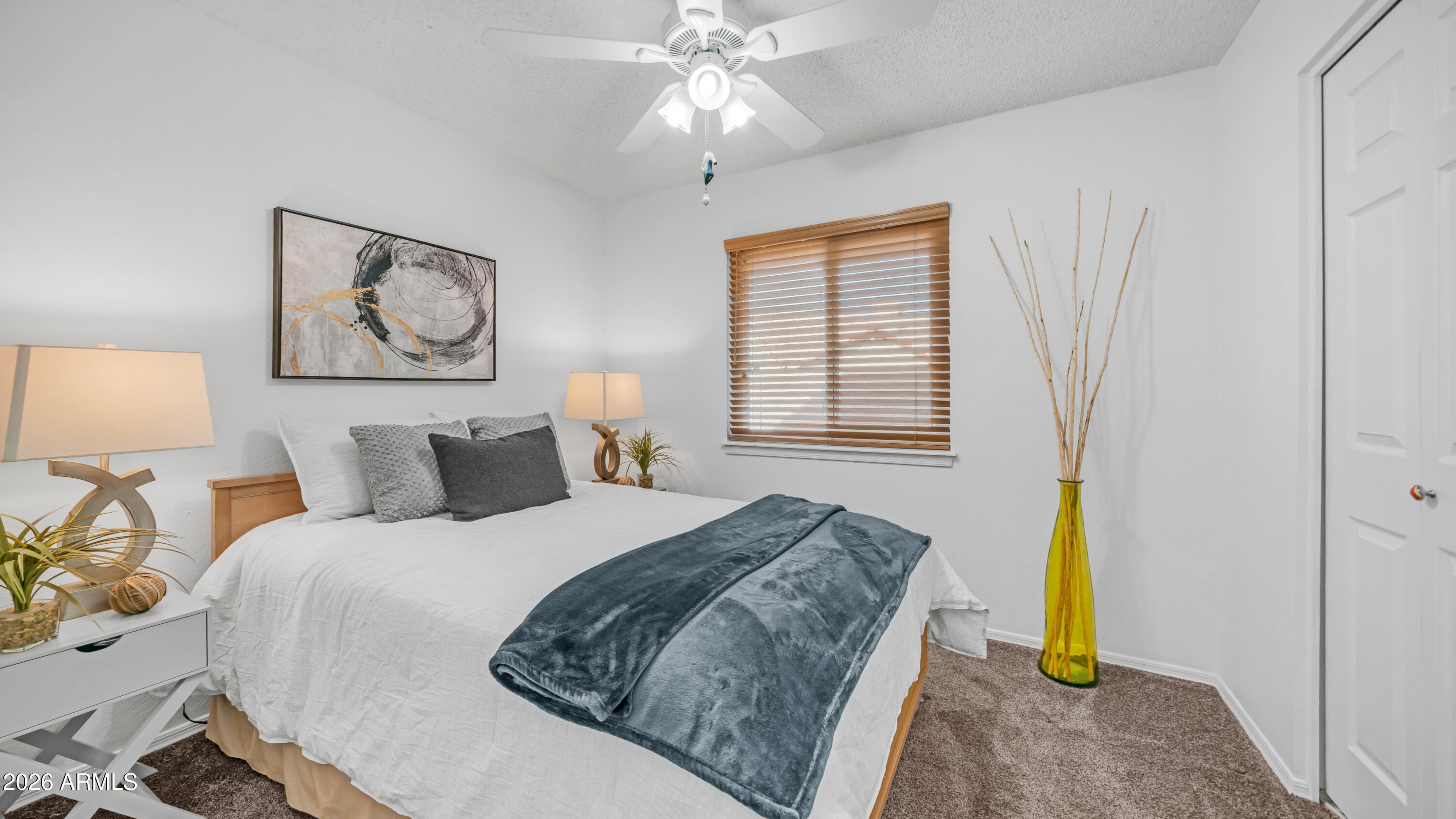 408 East Meadows Lane Gilbert, AZ 85234 - Photo 20 of 42 a bedroom with a bed and a chandelier