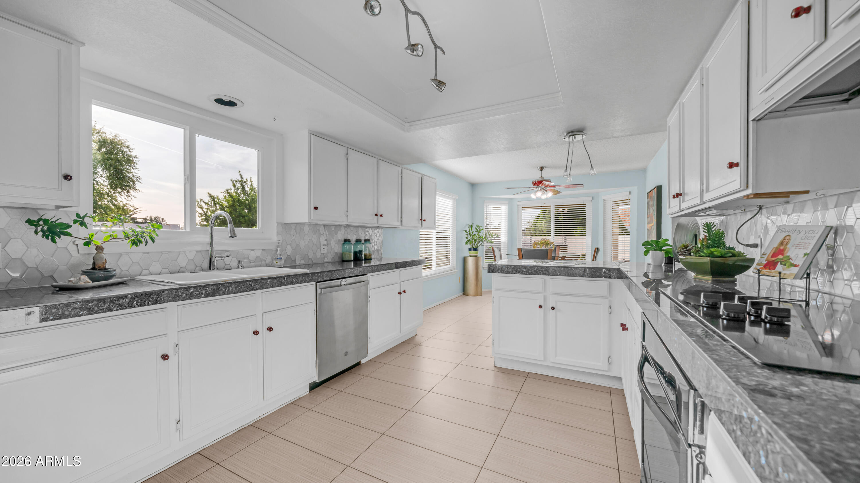 408 East Meadows Lane Gilbert, AZ 85234 - Photo 2 of 42 a kitchen with kitchen island granite countertop a sink white cabinets and window
