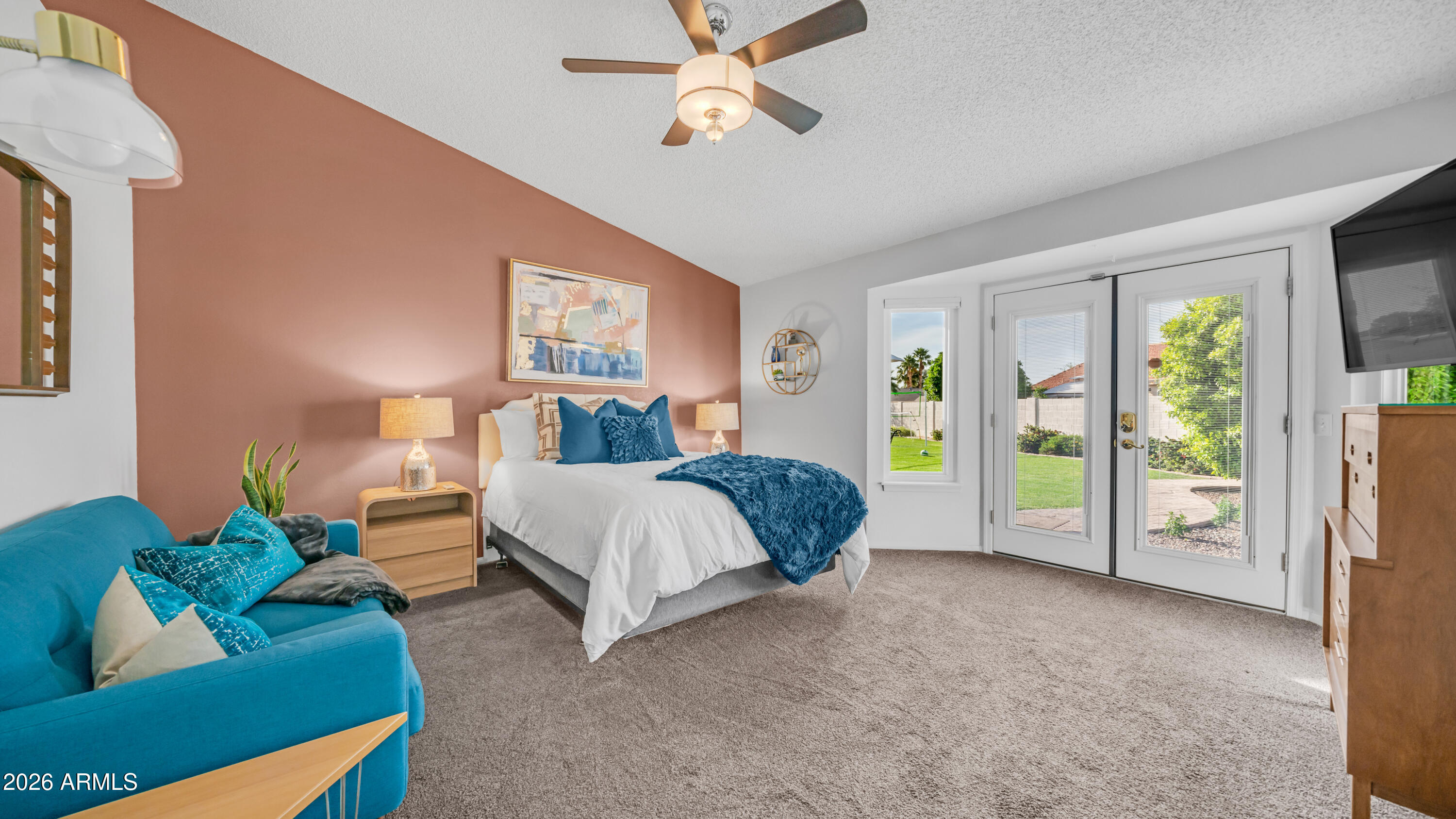408 East Meadows Lane Gilbert, AZ 85234 - Photo 22 of 42 a spacious bedroom with a bed and a chandelier