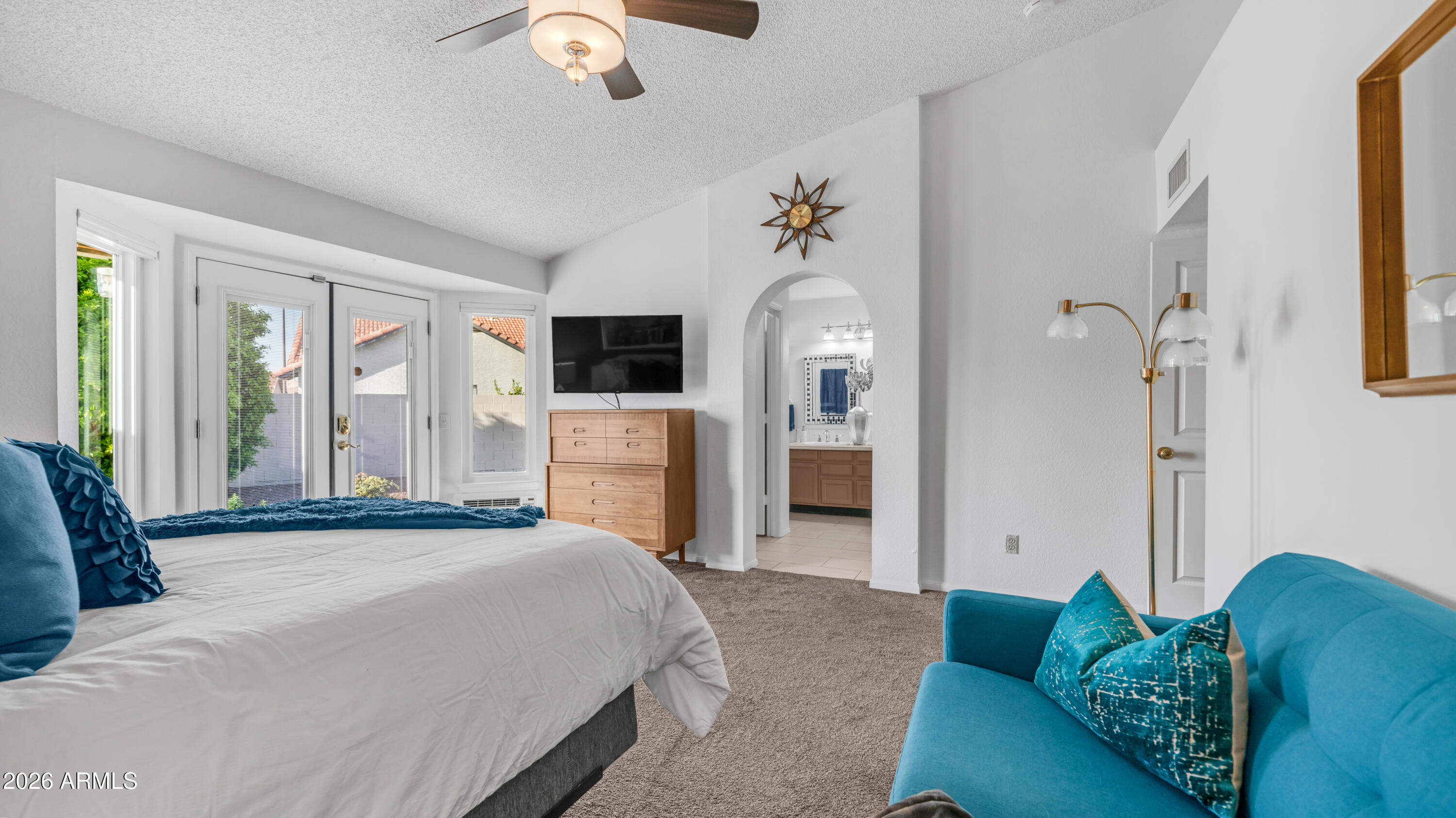408 East Meadows Lane Gilbert, AZ 85234 - Photo 23 of 42 a spacious bedroom with a bed couch and a window