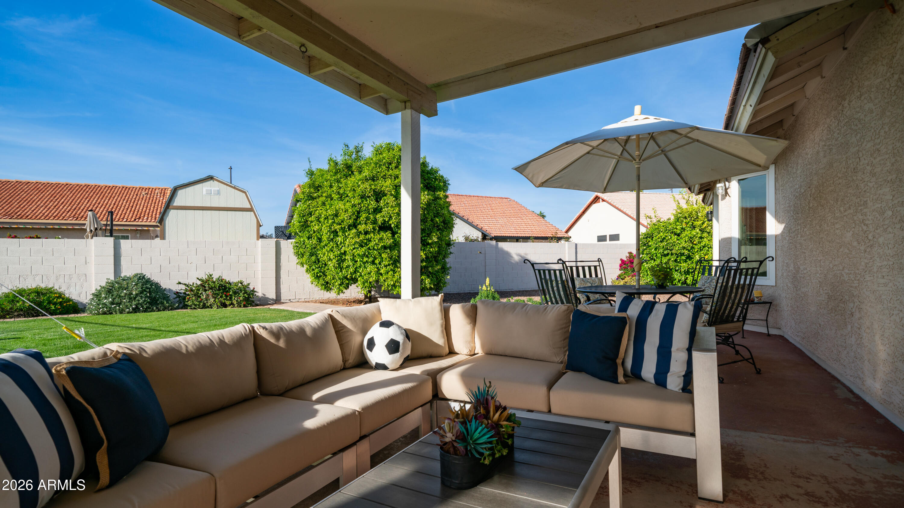 408 East Meadows Lane Gilbert, AZ 85234 - Photo 28 of 42 a view of patio with a table and chairs under an umbrella